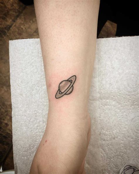 saturno tattoo|small saturn tattoo.